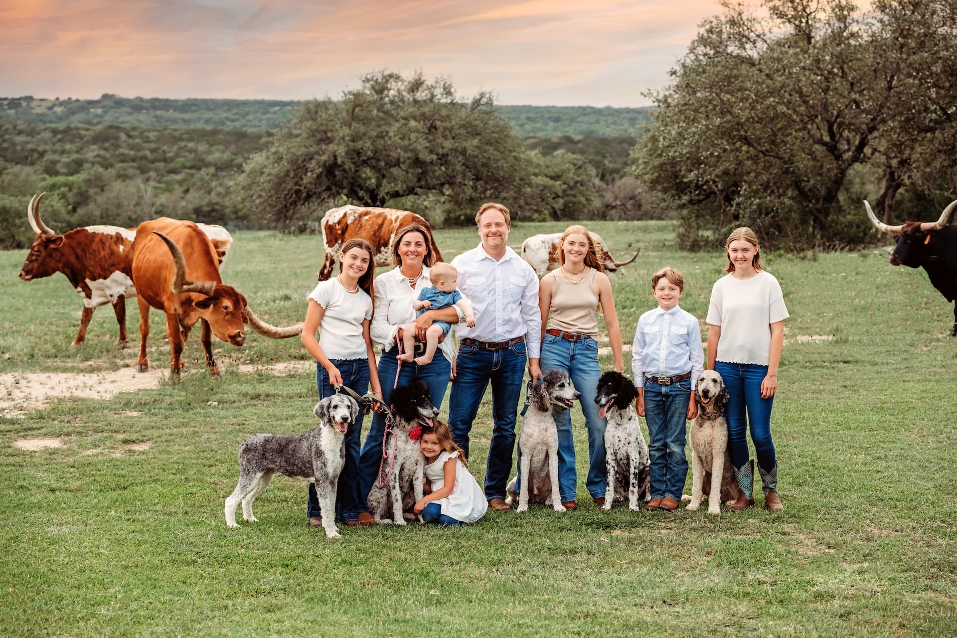 Purdy Poodles family with their standard poodles on the ranch in Texas Hill Country